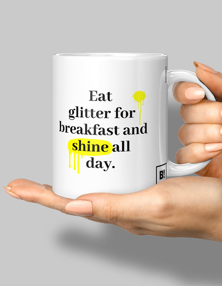 Hand holding a stylish mug from BINSPIRED's Everyday Quotes Mugs Collection, featuring an inspiring quote, set against a clean medium-light gray background for a modern and uplifting vibe.