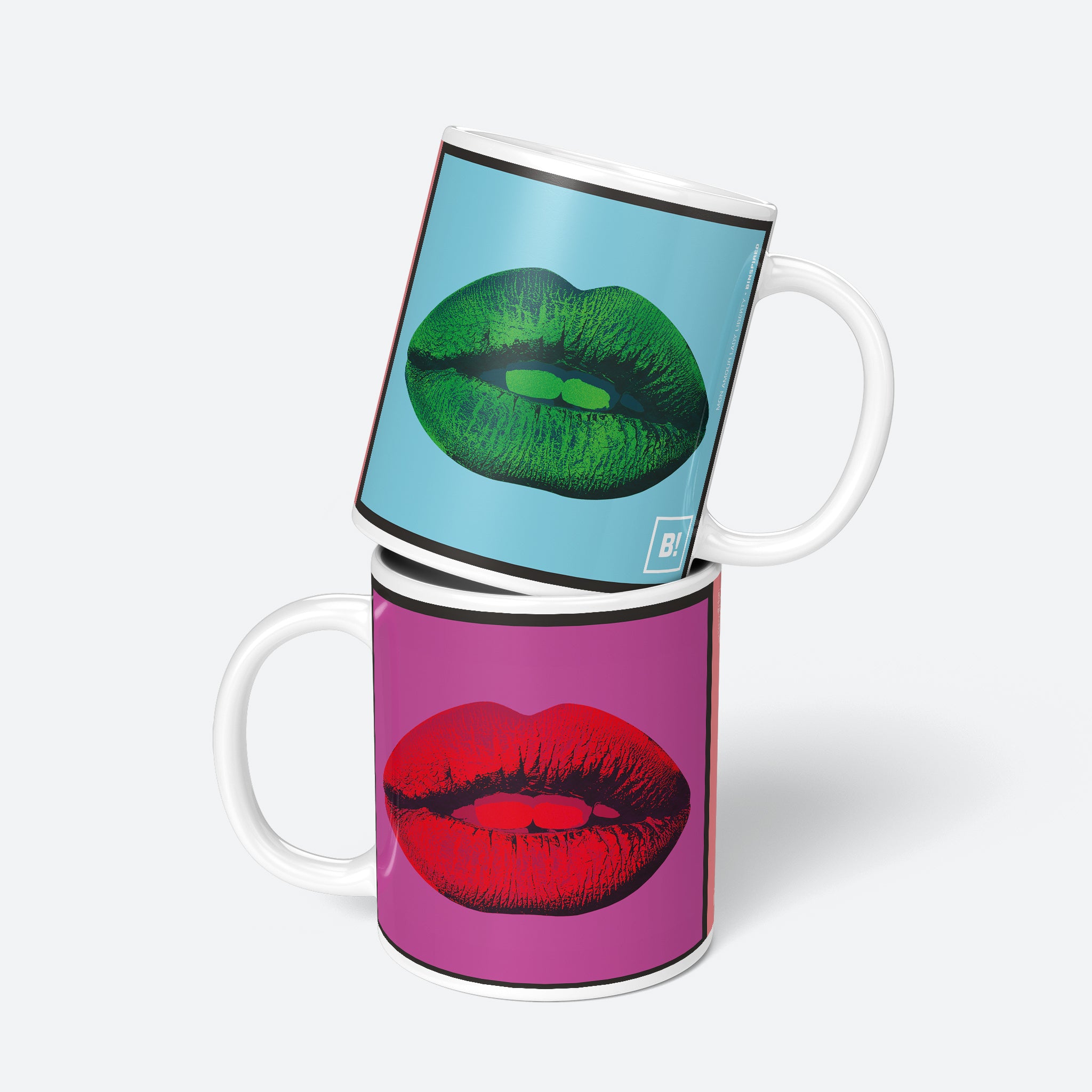 Stacked view of the Mon Amour Lady Liberty 11oz mugs, showing the mug's unique design with green lips, Liberty in pink, and vibrant background.